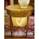 An Edwardian crossbanded satinwood sewing table, the oval quarter veneered top over two frieze