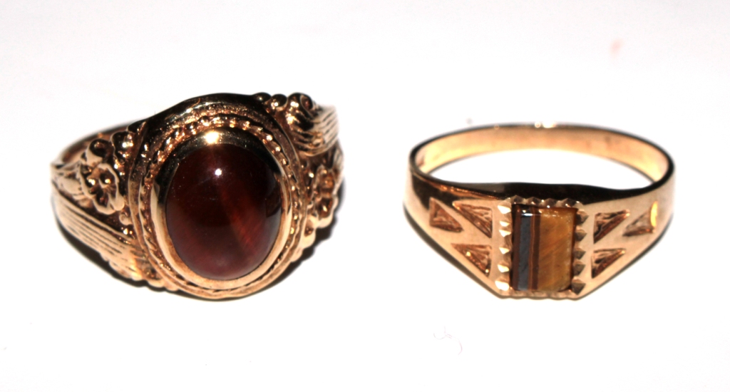 Two 9 carat gold rings set with tigers eye