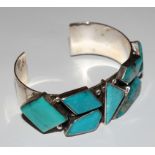 A silver and turquoise bangle
