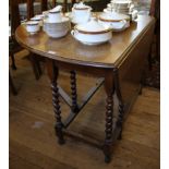 An oak drop leaf table with oval top on barley twist legs, 107cm wide