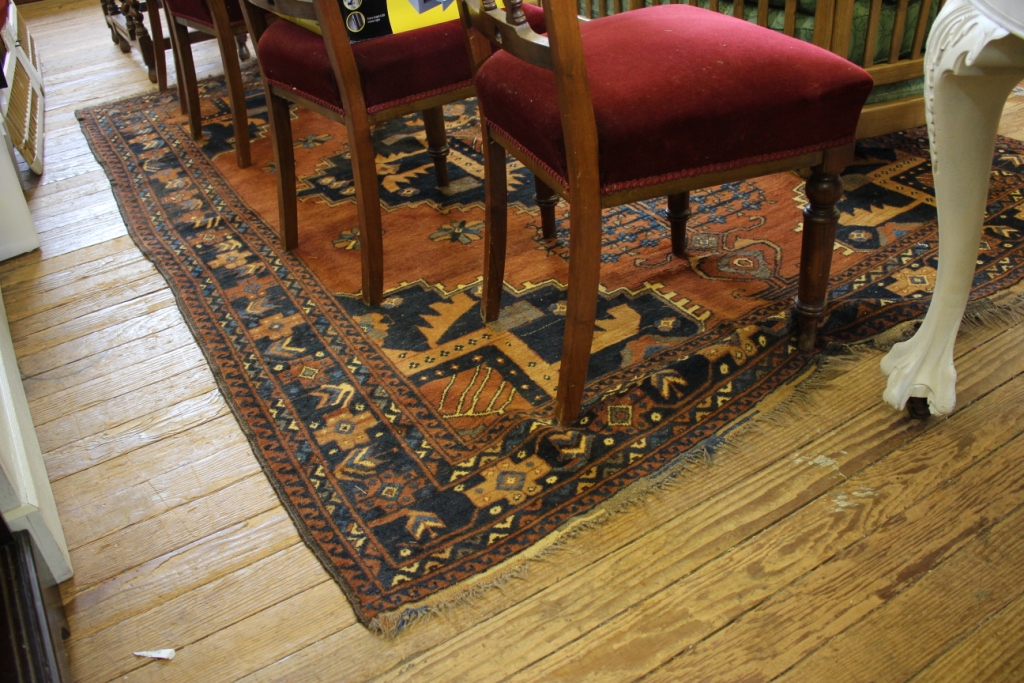 A Turkoman carpet, the rust filed with blue geometric medallion and spandrels within a multiple