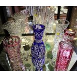 A cut glass red overlay decanter and stopper, two cut glass overlay vases and three other vases (6)