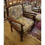 A pair of Imbuia wood colonial open armchairs, with scroll carved and rail backs on cabriole legs