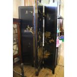 A black lacquered four fold screen, with gilt decoration of birds on blossoming branches, each panel