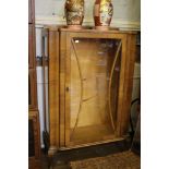 A 1930's walnut display cabinet, the shaped front with glazed door on cabriole legs, 73cm wide