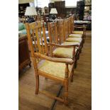 A set of six 1930's oak dining chairs, the rounded carved backs over serpentine rails, drop in seats