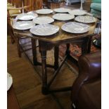 An oak Credence style table, with octagonal foldover top on turned and block baluster legs joined by