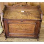 An Edwardian oak table writing desk, the pierced shaped gallery over a fall front with fitted