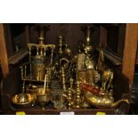 A collection of brasswares including horse brasses, ornaments and a brass occasional table