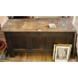 A 17th century oak chest, of planked construction with moulded rectangular top, the panelled front