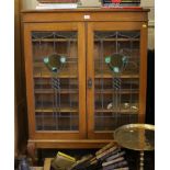 An oak display cabinet, with leaded glass doors on cabriole legs, 95cm wide