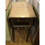 An early 19th century mahogany Pembroke table, the rounded drop leaves over two frieze drawers on