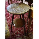 A carved wood tripod table, the circular top carved with flowers and lunettes on turned legs