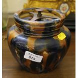 A blue and brown glazed tobacco jar with applied retirement inscription, 14cm high