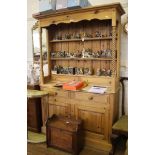 A pine dresser and rack, the shaped frieze and cornice on barley-twist supports with shelves and two