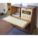 A walnut cased radiogram, with Regentone tuner and Collaro turntable, the fall front over a