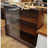 A mahogany veneer bookcase, with sliding glass doors, 97cm wide