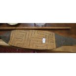 An Amazonian kyak paddle, with geometric decoration, 128cm high, and a timber and bone spear, with