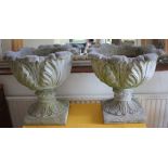 A pair of composite pedestal garden urns, of acanthus leaf form on square bases, 49cm diameter