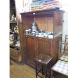 A mahogany bookcase cabinet, the open compartment over a pair of panelled doors on a plinth base,