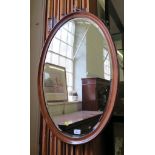 A mahogany oval mirror with bevelled plate, 81cm