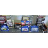 A collection of various die-cast models, including Rolls-Royce, Bentley, London Buses, Minis,