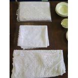 Three white lace style table cloths, 260cm x 150cm, 22cm x 140cm and 220cm x 120cm