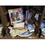 A Peter Rabbit figure by a wheelbarrow, Harry Potter Magic Chalice, various books on magic and other