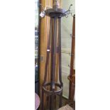 A 1920's mahogany hatstand, of circular form with four fluted supports on outswept legs, 203cm high