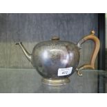 A bullet shape silver teapot having chased decoration, London 1934