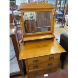 A late Victorian beech dressing table, the pierced pediment on a swing mirror over three long