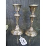 A pair of silver candlesticks, as found
