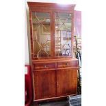 A yew wood veneer bookcase cabinet, with dentil cornice, astragal glazed doors, two frieze drawers