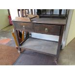 An oak side table/ trolley, with two frieze drawers on chamfered legs joined by undershelf on