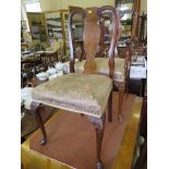 A crossbanded burr walnut Queen Anne style dining room suite, comprising a shaped rectangular dining