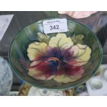 A Moorcroft small dish, the white and red orchid on a green ground, stamped marks, 11.5cm diameter