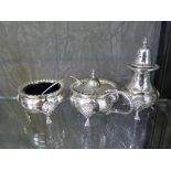 A substantial three piece silver cruet complete with blue liners