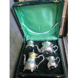 A cased four piece plated tea set and tray