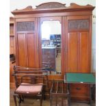 A late Victorian mirror front walnut wardrobe, the shaped carved pediment over a bevelled glazed