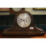 A 1930's oak 'Admiral Hat' style mantel clock, the beaded and panelled case with silvered dial