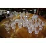 A set of six Edinburgh crystal champagne flutes, pair of brandy glasses and decanter, and various