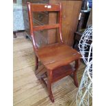 A modern stained wood metamorphic chair, converting into steps