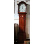 An early 19th century longcase clock, the moulded arched hood over a plain trunk with arched door