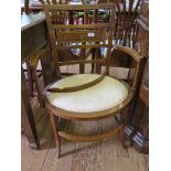 A pair of Edwardian mahogany open armchairs with boxwood stringing, the backs with trophy and swag