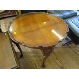 A quarter veneered walnut occasional table, with pie crust edge, on shell carved cabriole legs, 68.