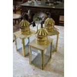 A set of three brass carriage lamps, of rectangular form, 34cm high