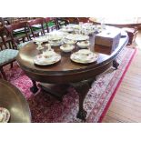 An early 20th century crossbanded mahogany extending dining table, the ovoid top with beaded edge