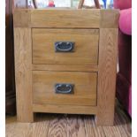 A pair of oak small chests with two short drawers, each 50cm wide, 57cm high