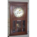 A 1920's oak wall clock, with silvered dial, 48cm high