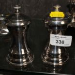 A pair of silver plated pepper mills